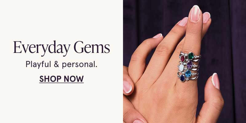 Hand wearing colorful gemstone rings. Everyday gems. Playful & personal. Click here to shop now