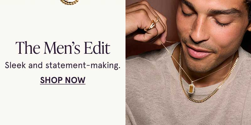 Male model wearing gold jewelry with colored pendants. The Men’s Edit. Sleek & statement-making. Click here to shop now