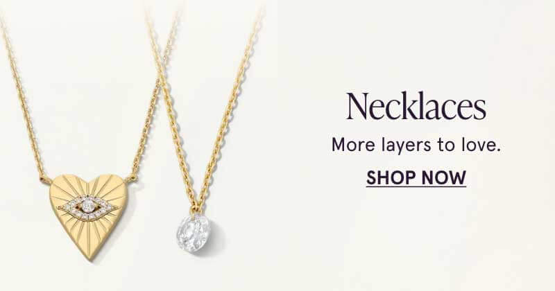 Two gold necklaces with circle-cut diamond, and heart with eye-design pendant attached. Necklaces. More layers to love. Click here to shop now