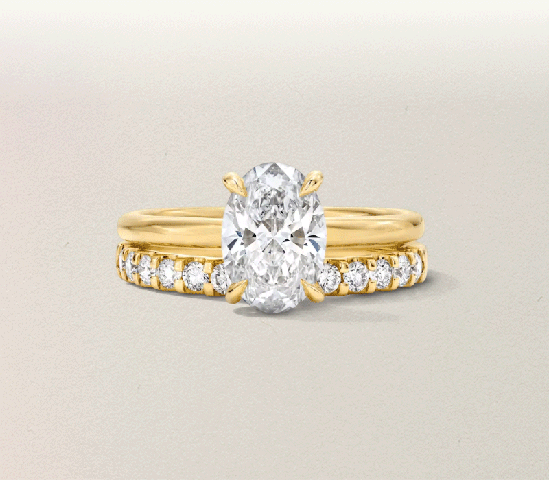 Rotating images of silver and gold rings with varied stone cuts and settings.
