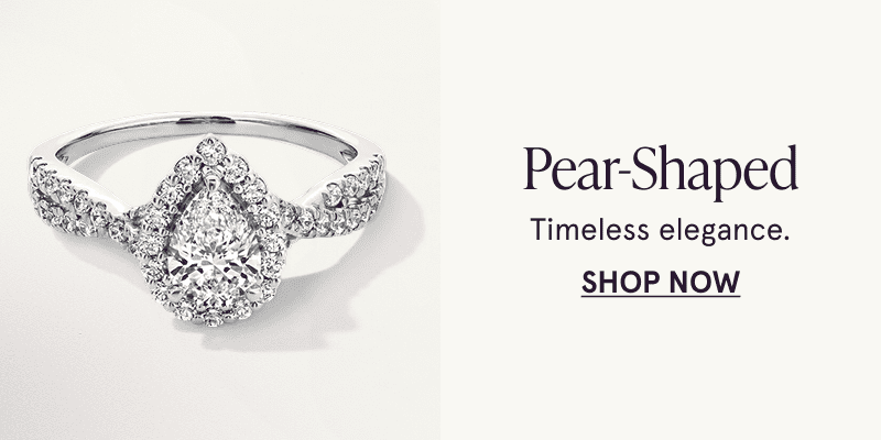 A white metal multi diamond ring with a pear shaped center stone. Timeless elegance. Click here to shop pear shaped styles