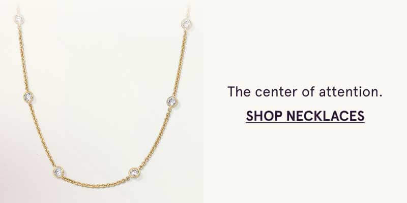 Gold chain with evenly spaced round diamonds along. Center of attention. Click here to shop necklaces