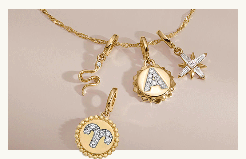 Interchangeable charms one-by-one appear on gold chain including a horoscope and initial pendant.