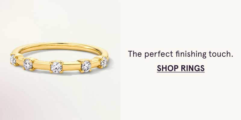 Yellow gold ring featuring spaced round diamonds set across. Finishing touch. Click here to shop rings