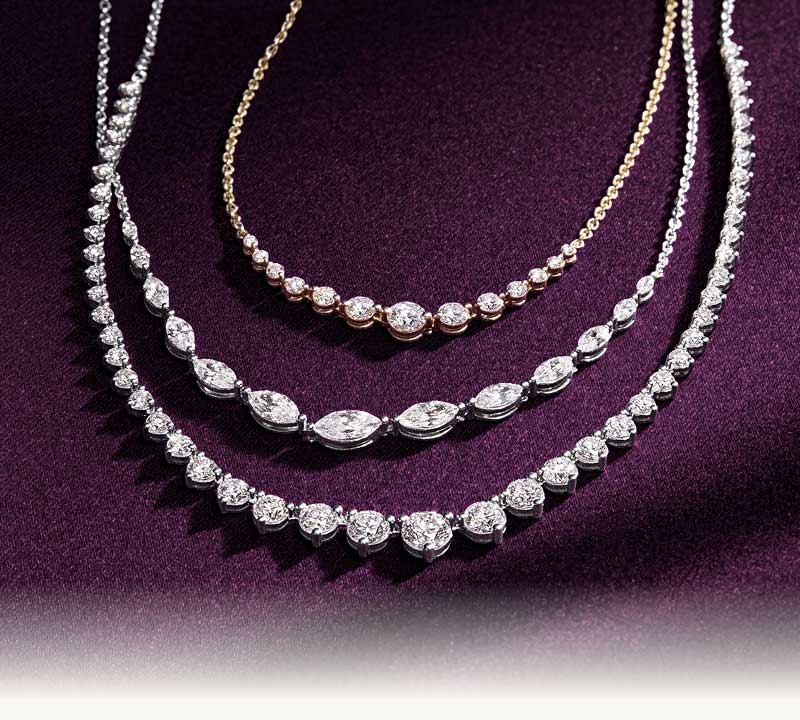 Three diamond necklaces featuring a variety of stone shapes including round, marquise and pear.
