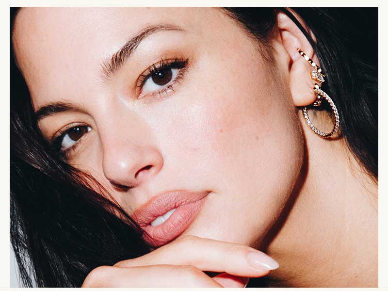 Ashley Graham layered in diamond & gemstone jewelry. 